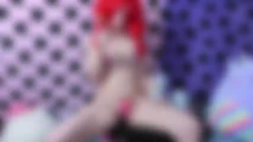 Linda masturbación con un consolador de cuerno de unicornio de color pastel en bikini de corazón y peluca roja mientras lamo una paleta de colores.