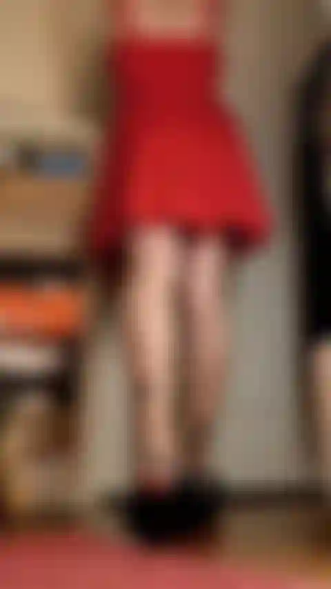 Vestido rojo, piernas largas, se doblan, se ven las suelas.