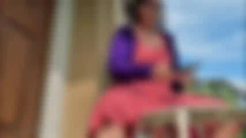 Vestido rojo encorvado, dedos rojos, chanclas de brasil cuelgan.