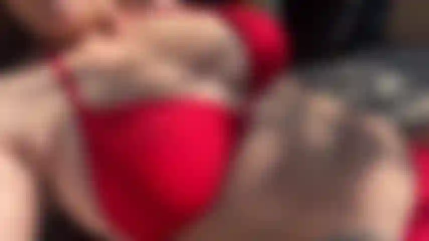 Naughty wife. Up and down slo mo view of me in red bikini on a lounger sunbathing