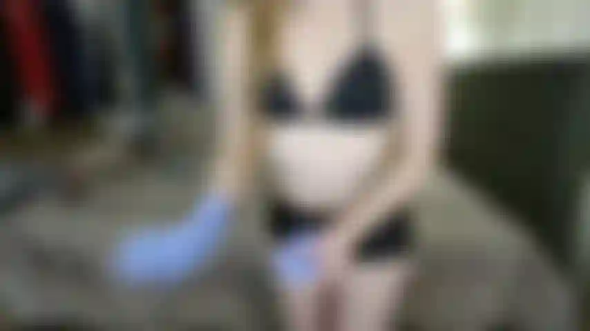 Pantalones cortos negros brillantes, guantes de examen morados y axilas peludas (no desnuda).