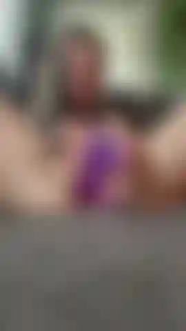 wearing a dress w/purple dildo