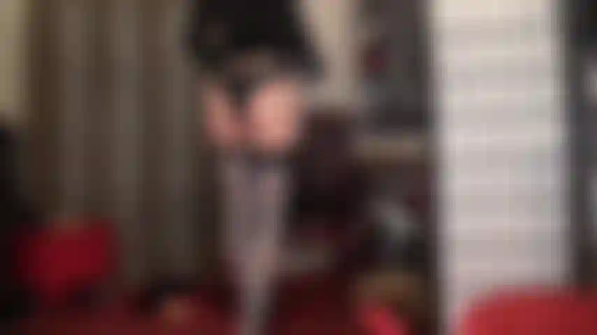 Medias azul grisáceas brillantes sobre pantimedias color piel con botas de tacón de aguja con cordones azules.