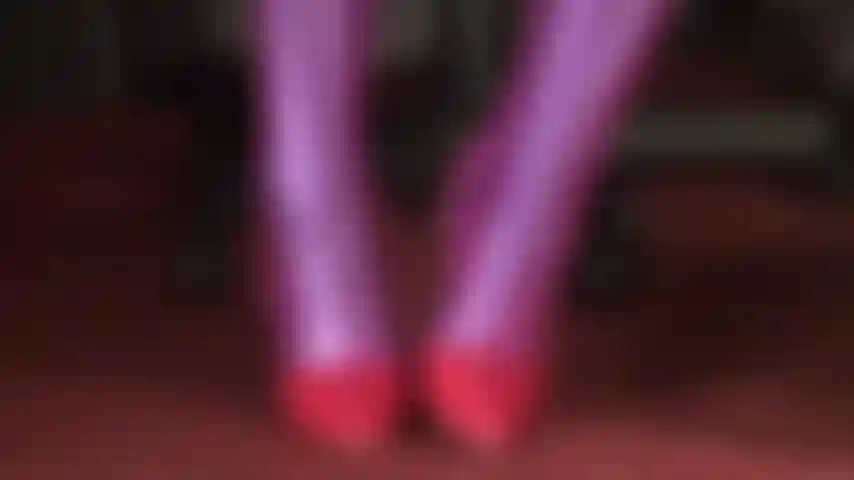 Fetish Art - Mistress displays pure fetish art wearing pink fishnets on purple Leohex spandex tight, paired with shiny red stilettos, gently touched by black leather gloves.