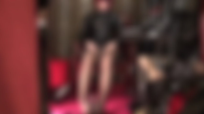 Ama acaricia dos pollas - vestida con pvc brillante y medias marrones, sus pies están envueltos alrededor de una polla negra mientras la ama acaricia su strap-on blanco con las manos desnudas.