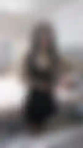 Aceitando mi top de látex semitransparente y mi falda de látex negra, mostrando el coño.