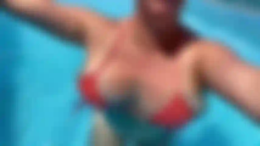 Pool Tease- Im wearing a tiny orange bikini while bouncing and jiggling my tits in my pool.