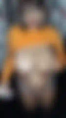 Velma playing with a vibrator and body oily